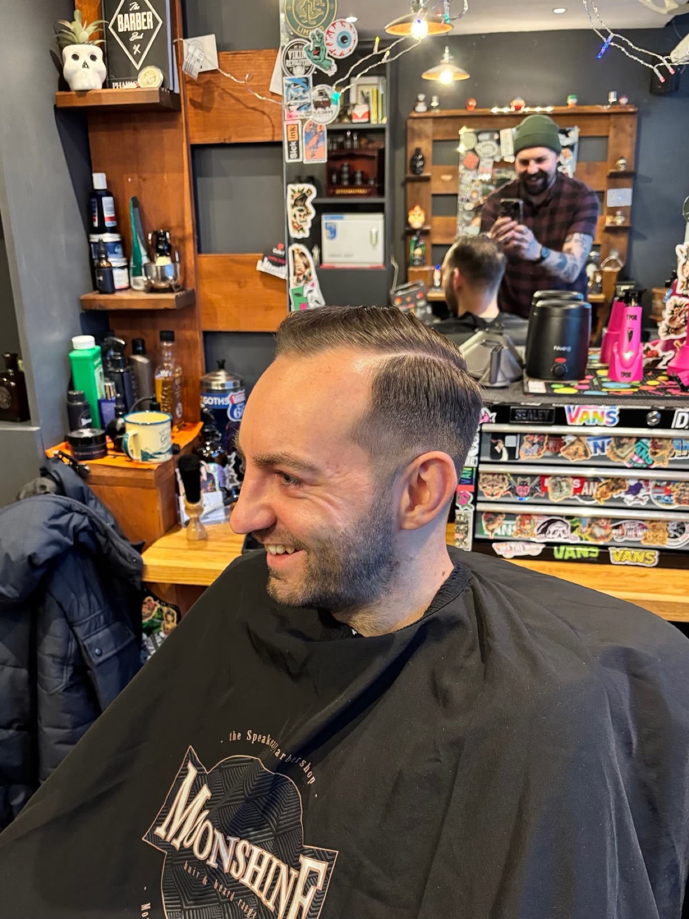 Client after haircut smiling in the barbershop
